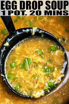 an egg drop soup recipe in a pot with green onions and cheese on top, ready to be eaten