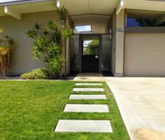 a house with grass and steps leading to the front door