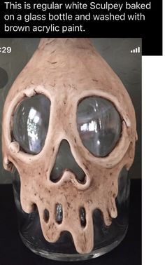 a fake human skull in a glass jar with eyes on it's head and the caption reads, this is regular white sculpey baked