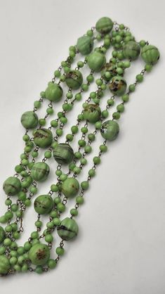 Vintage extra long milifiore green glass bead necklace. Each bead is individually wire wrapped by hand. Overall in very good to excellent condition. Measures about 54" long end to end. Bohemian Multi-strand Green Beads, Bohemian Green Multi-strand Beads, Green Beaded Glass Jewelry, Handmade Green Beaded Lariat Necklaces, Handmade Green Lariat Beaded Necklace, Green Glass Beaded Jewelry, Green Vintage Glass Beaded Necklaces, Vintage Green Glass Beaded Necklaces, Adjustable Green Beads Long Necklace