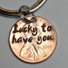 a penny keychain with the words lucky to have you engraved on it's side