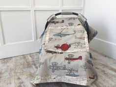 a baby stroller sitting on the floor in front of a white door with an airplane print