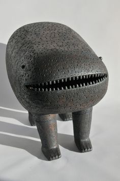 an odd looking object with holes in it's mouth and teeth on its back