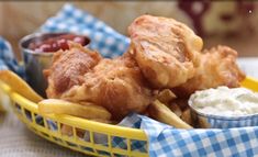 a basket filled with fried food on top of a table