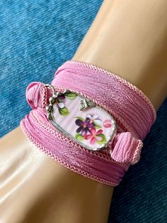 a pink bracelet with flowers on it