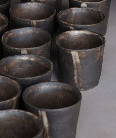 many black pots are lined up on the floor and ready to be used as planters