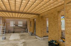 the inside of a house being built with wood framing and plywood panels on the ceiling