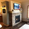 a living room with a fire place and television