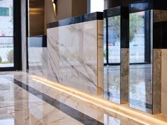 the marble wall is lined with black and white tiles