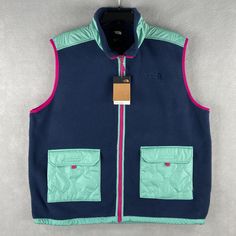 This Listing Is For A New With Tags The North Face Men's Xxl Royal Arch Vest. Standard Fit, Full Zip, 2 Hook & Look Pockets, Drawstring Waist, Blue & Mint Green. 100% Polyester, Cotton, Machine Washable. Approximate Measurements Are As Follows: Shoulder-To-Shoulder: 20" Armpit-To-Armpit: 27" Top-To-Bottom: 30" Sleeve (From Shoulder Seam): N/A Color Disclaimer: Please Note Actual Color May Vary Slightly From What You See On Your Monitor/Screen. Your Individual Monitor Settings And Screen Brightne Blue Outerwear With Cargo Pockets And Long Sleeves, Blue Long Sleeve Outerwear With Cargo Pockets, Navy Outerwear With Pockets For Outdoor Activities, Blue Utility Outerwear With Side Pockets, Navy Utility Outerwear With Pockets, Blue Utility Outerwear With Flap Pockets, Casual Hiking Outerwear With Flap Pockets, Blue Streetwear Outerwear With Cargo Pockets, Blue Outerwear With Patch Pockets For Outdoor