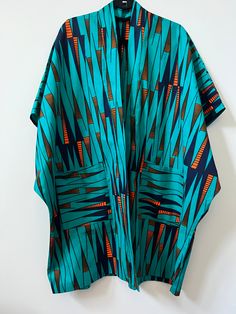 Up your style with this beautifully unique Kimono - they always make a statement! Crafted from African Wax Print fabric. Style with jeans, a skirt or dress. Open front Midi length Kimono style Relaxed, oversized fit Lightweight Short sleeves Patch front pockets 100% Cotton. One Size. Length = 38.5" African Kimono, Unique Kimono, Kimono Styles, African Print Kimono, Moda Kimono, African Wax Print Fabric, Mode Kimono, Bespoke Clothing, Wax Print Fabric