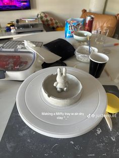 a white plate topped with a cake on top of a table