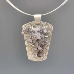 "This pendant features a gorgeous, one of a kind piece of druzy Grape Agate. It's prong-set in sterling silver, which has hammered radiating lines and a lovely satin finish.  Grape Agate (or Grape Chalcedony) is a form of chalcedony found in Indonesia. It forms in clusters of little balls that often resemble bunches of small grapes, and colors can range from pale to deep purple to green. Some specimens - like this one! - can be quite sparkly due to minute quartz crystal growing on the spheres. The pendant measures 1 7/8\" long and 1 1/4\" wide, and includes an 18\" multi-strand steel cable necklace." Radiating Lines, Crystal Growing, Grape Agate, Ideas Jewelry, Agate Jewelry, Artistic Jewelry, Multi Strand, Deep Purple, Druzy