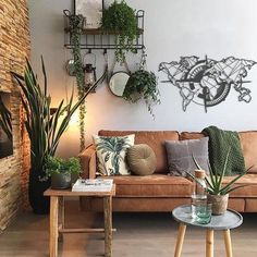 a living room filled with furniture and plants