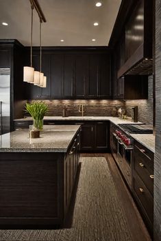 a kitchen with dark wood cabinets and granite counter tops, along with an island in the middle