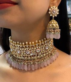 The Kundan necklace set with Pastel Pink Rose Quartz stones is a beautiful piece of bridal jewelry designed and handcrafted by Indian artisans with traditional Indian Jewelry making techniques The lustrous beauty of the antique Kundan gold-plated necklace instills a sense of nostalgia and likely takes you down to old memories. Sabyasachi jewelry inspired Kundan necklace set is an epode to the rich culture of India with its matching jhumka earrings that bring together the blend of techniques and Pink Bollywood Style Ceremonial Jewelry, Pink Kundan Necklace For Ceremonial Occasions, Pink Bollywood Ceremonial Jewelry, Pink Bollywood Jewelry For Ceremonial Occasions, Pink Bridal Necklace For Ceremonial Festivals, Pink Bollywood Kundan Necklace For Ceremonial Occasions, Pink Bridal Necklace For Festive Ceremonial, Pink Bridal Necklace For Ceremonial Festive Occasion, Traditional Kundan Necklace With Latkans For Reception