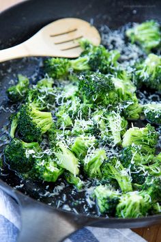 cooked broccoli with parmesan cheese in a skillet