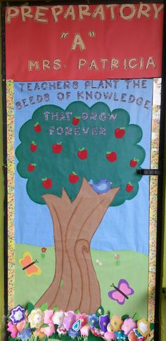 a classroom door decorated with flowers and an apple tree for the teacher's picnic