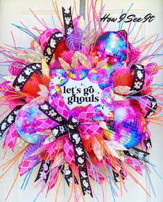 the front door is decorated with bright colored mesh and bows that say let's go ghouls