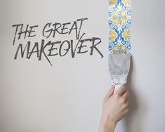 a person is painting the wall with white paint and black lettering that says, the great makeover