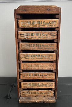 an old wooden box with six different types of pizza boxes on it, and one is empty