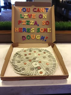 an open pizza box with the words you can't live on pizza so here is some dough