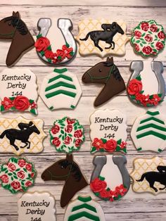 decorated cookies with horses, roses and ribbons for kentucky derby day on a wooden table