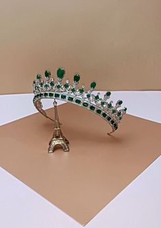 The MAJESTC EMERALD Bridal Crown is one of our most luxurious Bridal Tiara with Stunning Design. It is inspired after Queen Victoria's wedding crown. It is a Majestic Swarovski Bridal Crown that is timeless and classic to complete the bridal look.  The design is made up of tear drop and round crystals with a unique design to give it the an outstanding look. It is a royal statement piece fit for a queen on her wedding day.   Available as Regular Crown ( 3/4 crown) and Full Crown (full circle crow Full Circle Crown, Bride Necklaces, Queen Victoria Crown, Queen Victoria Wedding, Emerald Crown, Fantasy Accessories, Green Crown, Royal Crowns, Egyptian Style