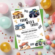 a birthday card with monster trucks on it, surrounded by balloons and confetti