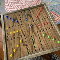 an old wooden board game sitting on top of a table next to a pair of slippers