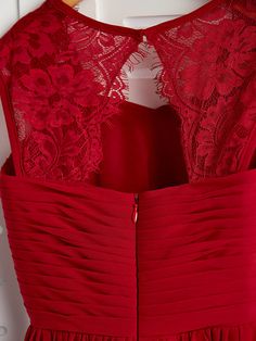 the back of a red dress on a mannequin