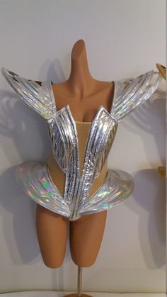 a mannequin with shiny silver wings on it