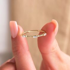 Our dainty Baguette Diamond Gold Beaded Ring is a beautiful and dainty piece, perfect for adding a touch of elegance to your jewelry collection. Crafted from 18K gold, this beaded band features 3 baguette diamonds, making it a standout minimalist gold ring. The delicate gold ring design is ideal for stacking with other rings, whether you're looking for a matching ring, everyday ring, or anniversary ring. This petite ring is perfect as a stackable gold band, adding a little more bling to your eve Baguette Jewelry, Minimalist Gold Ring, Delicate Gold Ring, Stackable Rings Wedding, Ring Everyday, Petite Ring, Baguette Diamond Rings, Diamond Stacking Rings, Baguette Ring