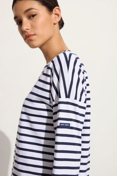 The Minquiers II is a relaxed Breton striped top with drop shoulder detail and Saint James logo on sleeve. Made in Saint-James, Normandy, France. White background with navy blue stripes. Drop Shoulder Top, Normandy France, Saint James, French Brands, Warm Sweaters, Reduce Wrinkles, Striped Blouse, Striped Tee, Blue Stripes