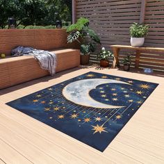 an outdoor area rug with the moon and stars on it