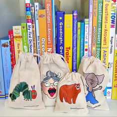 three bags with cartoon characters on them are sitting in front of a bookcase full of books