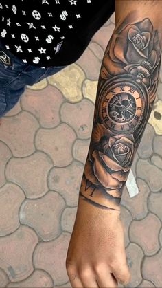 a man's arm with a rose and watch tattoo on the left side of his arm