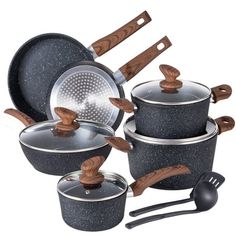 an assortment of pots and pans with wooden spoons in them on a white background