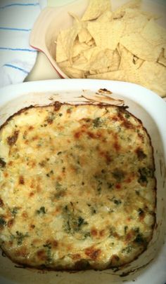 a casserole dish with tortilla chips on the side