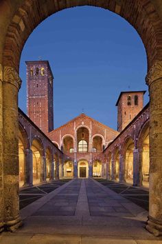 an archway leading into a building with tall towers