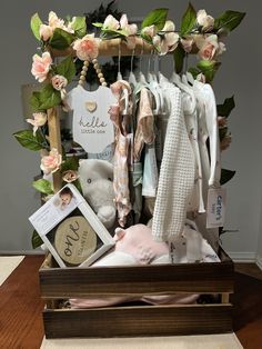 a wooden box filled with baby items on top of a table