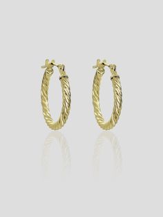 With a new take on classic hoops, this piece is meant to be worn every single day. A minimalist style inspired by a twisted finish. This piece is effortlessly chic and essential to your collection. These earrings come in smaller size. Details: Made in 14K Solid Yellow Gold Dimensions: L 1.1cm - W 1.1cm Color: 14K Solid Yellow Gold / 14K Solid White Gold Hypoallergenic Fine Jewelry