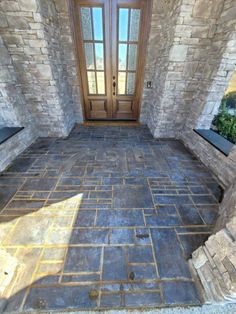 an entry way with stone walls and doors