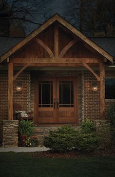 a lit up house at night with the front door and sidelights on it's windows