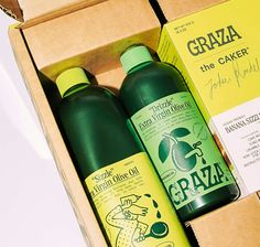 two bottles of graza are sitting in a box