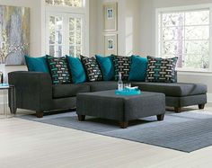 a living room filled with lots of furniture and pillows on top of a blue rug