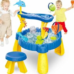 two children playing in a water play table