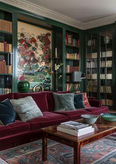 a living room filled with furniture and bookshelves covered in lots of bookcases