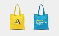 two tote bags, one blue and one yellow with the words'a delix on - apprend mix '