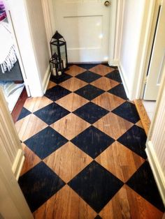 an empty hallway with a lantern on the floor and a door in the back ground